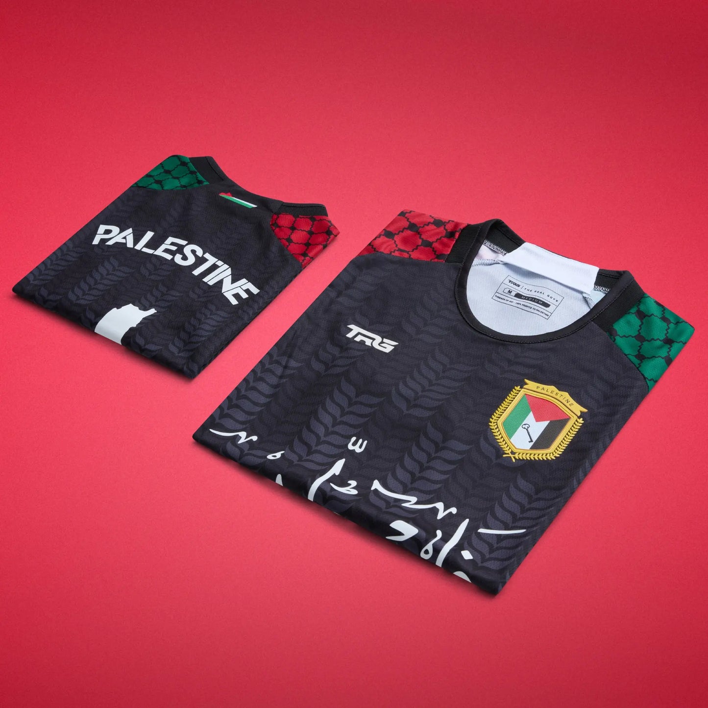 Folded front and back views of the black TRG Kids Palestine football jersey on a red background, highlighting the Arabic calligraphy, Palestine badge, “PALESTINE” lettering and patterned sleeves.