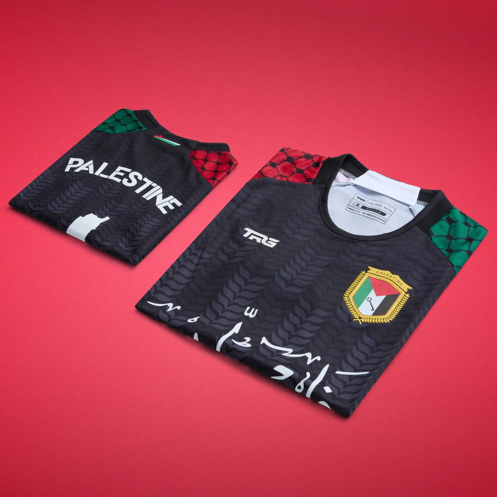 Folded front and back views of the black TRG Kids Palestine football jersey on a red background, highlighting the Arabic calligraphy, Palestine badge, “PALESTINE” lettering and patterned sleeves.