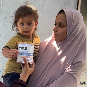 Mother and young child receiving The Real Guys baby formula distribution in North Gaza