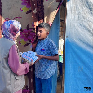 Boy receiving bread distribution package from The Real Guys and Al-Qulub Trust in Gaza
Next.