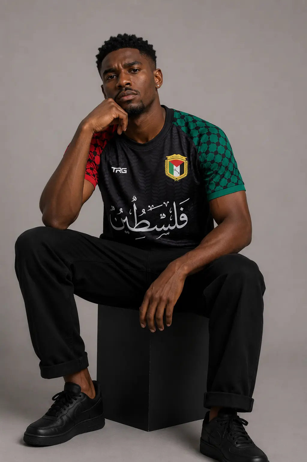 Black short sleeve Palestine jersey · seated · The Real Guys